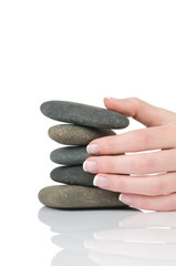 Female hands holding pile of stones isolated on white