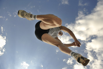 Obraz na płótnie Canvas athlete running and jumping