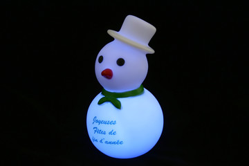Snowman rests in a ball of colored tensile