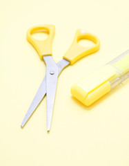 Yellow scissors and a marker
