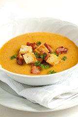 vegetable puree soup with rusk, bacon and parsley