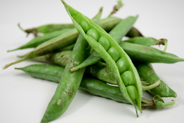 green peas in their pod isolated on white