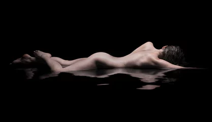 Fotobehang Naakte vrouw ligt in het water, rustig © Belphnaque