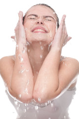 Close-up of beautiful woman washing her face