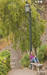 Blonde woman relaxing on a park bench in Santiago, Chile.