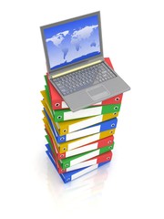 Colorful books next to a modern laptop