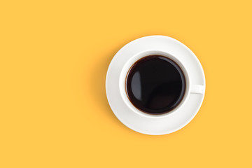 Top view of black coffee cup on yellow background