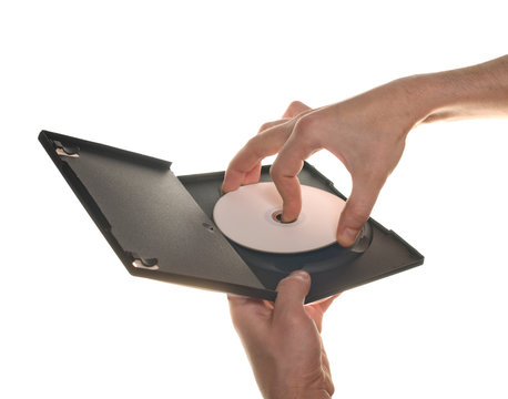 Men's hand holding DVD CD disc on white background isolated