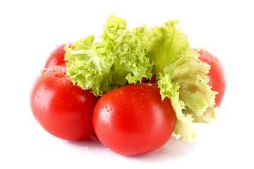 Few tomatoes and green salad isolated on white