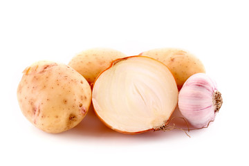 Potatoes, onion and garlic isolated on white