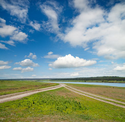 Fototapeta premium two rural road in green field