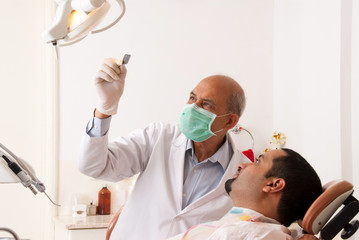 Dentist looking at an x-ray with a patient