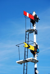 Fototapeta premium Old Railway Signals in UK against blue sky with copyspace in Pickering North Yorkshire