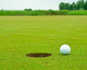 Golfball very close to the hole