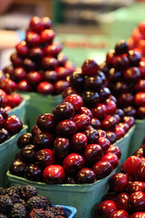 Cherries piled up in a pyramid at a farmer's market