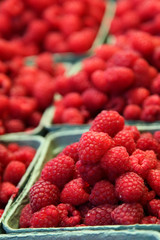 Raspberry basket with fruits piled up in a pyramid
