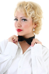 woman in white shirt correcting a bow-tie