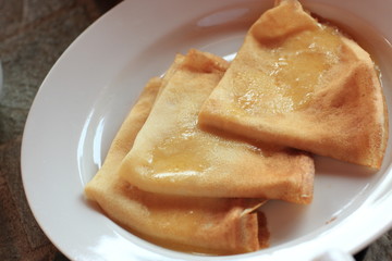 Three pancakes with melted butter