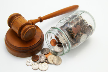 legal court gavel and money from a coin jar