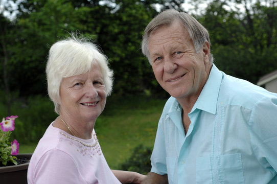 Senior couple shares some tender moments in their garden.