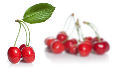 red cherry with leaves isolated on white