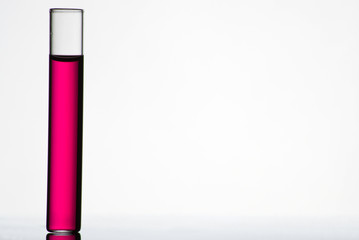 Test tube filled with colored liquid on white