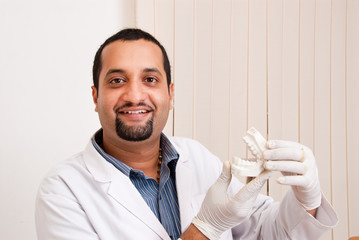 Dentist holding a teeth mold