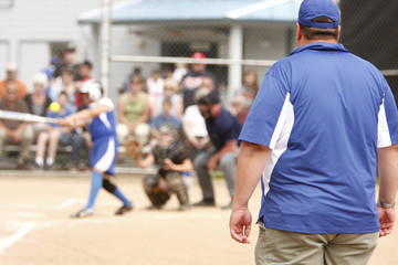 Coach watching player up to bat