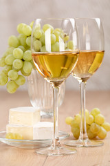 Still-life with bunch of grapes and white wine