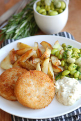 Fish cakes with chips and broad beans