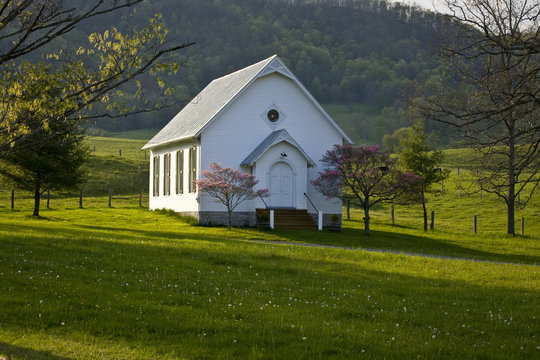 White wooden country church on hilltop in Virginia mountains.