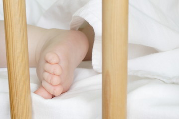 sleeping baby in a crib - obrazy, fototapety, plakaty