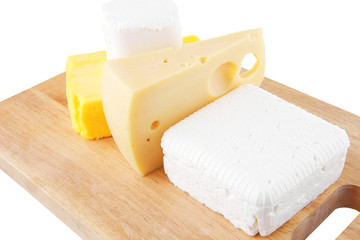 cheeses on wooden board