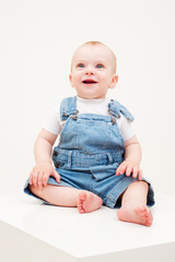 happy baby in dungarees