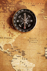 Obraz na płótnie Canvas An old brass compass on a Treasure map background