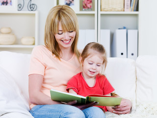 Mother with daughter reading the book