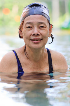 Senior Asian Woman in Swimming Pool
