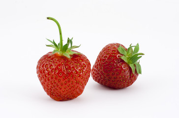 Two strawberries leaning