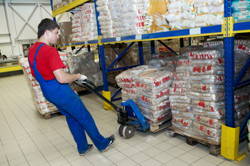 warehouse worker with forklift stacker