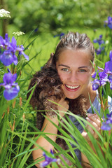 Portrait of a girl with dog surrounded with blue flowers