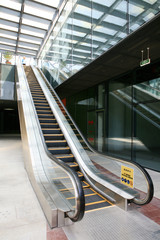 moving escalator in the office hall perspective view