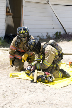 fire fighters prepare equipment to fight house fire