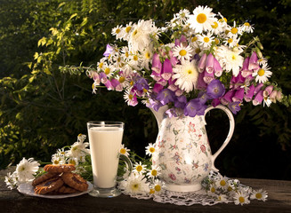 Summer bouquet in a jar and milk