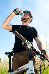 closeup of a young biker drinking water