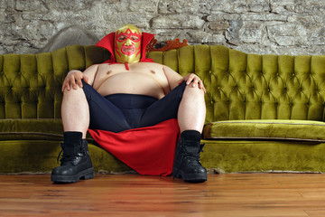 Mexican wrestler sitting on a couch - 23928033
