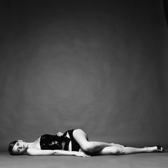 Seductive woman lays on floor - obrazy, fototapety, plakaty