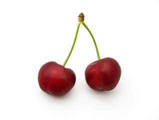two isolated red cherries