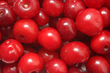 Ripe red cherries closeup photo as background