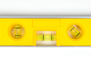 Yellow spirit level isolated on a white background
