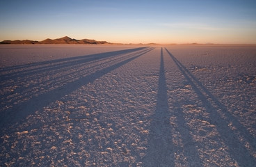Sunrise casting magnificent shadows over Bolivian Salt Flats.